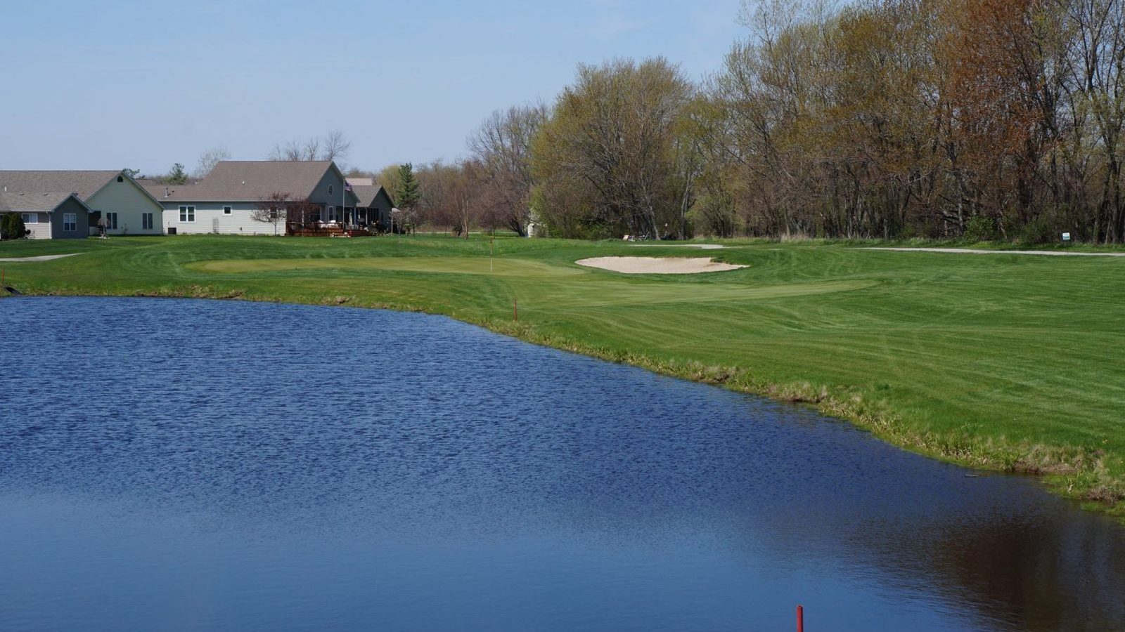 view of green next to a water hazard