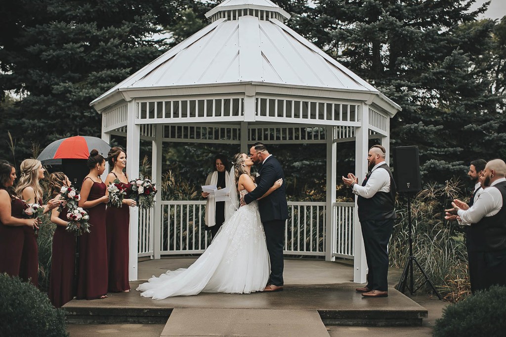 bride and groom kissing at outdoor wedding